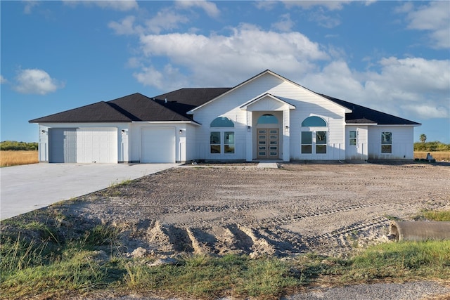 ranch-style house with french doors and a garage