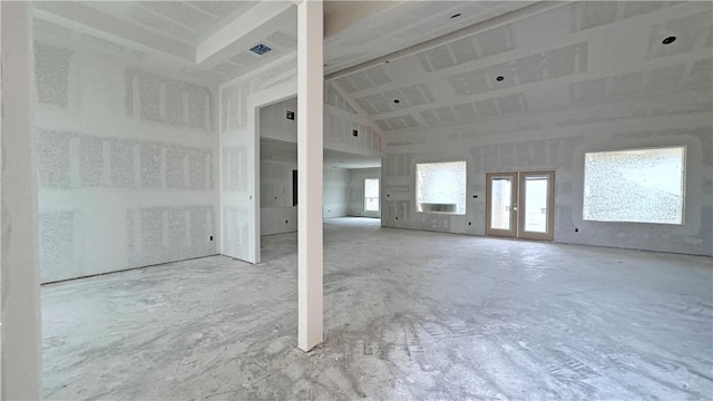 spare room featuring french doors and vaulted ceiling