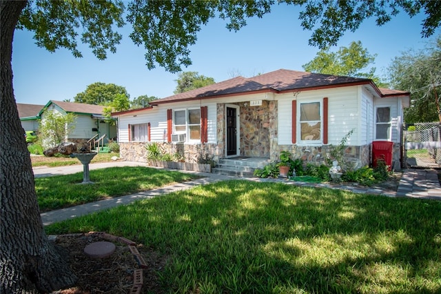 view of front of house with cooling unit and a front yard