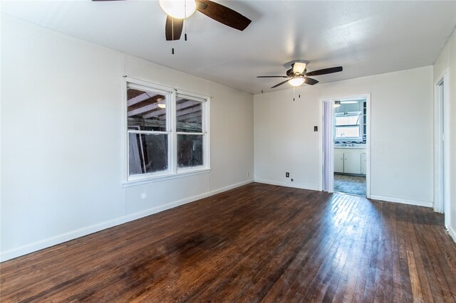 unfurnished room with dark wood-type flooring and ceiling fan