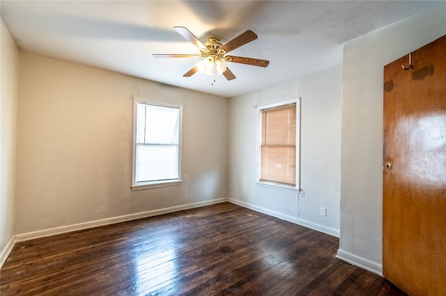 spare room featuring ceiling fan and dark hardwood / wood-style floors