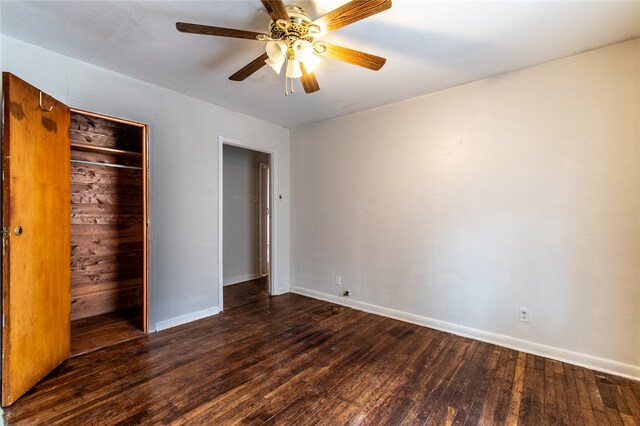 unfurnished bedroom with a closet, ceiling fan, and dark hardwood / wood-style floors