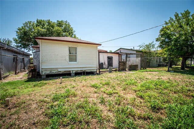 rear view of property with a yard