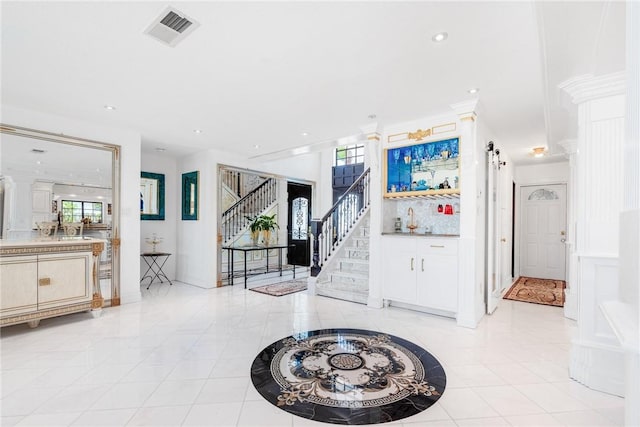 entrance foyer featuring recessed lighting, visible vents, stairs, and light tile patterned floors