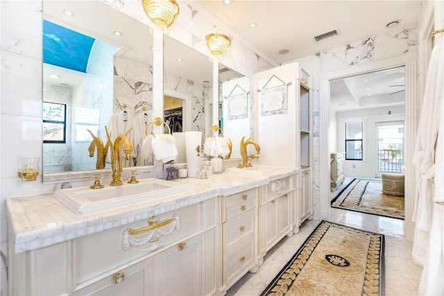 bathroom with visible vents, marble finish floor, and a sink