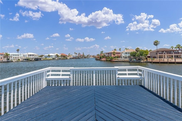 wooden terrace with a residential view and a water view