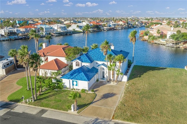 drone / aerial view featuring a residential view and a water view