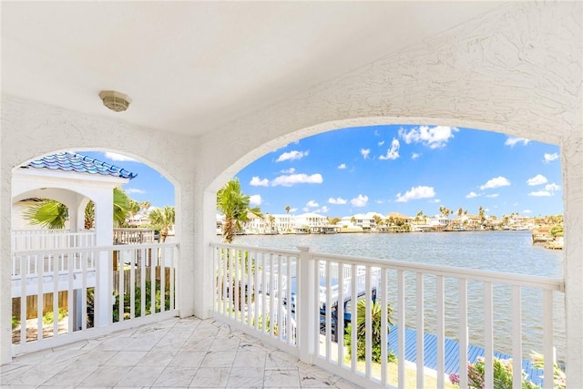 view of patio / terrace with a water view and a balcony