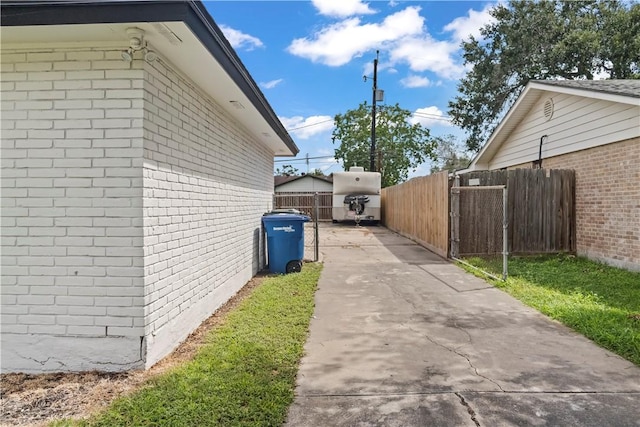 3614 Capri Dr, Corpus Christi, TX 78415 - view of side of home with brick siding and concrete driveway