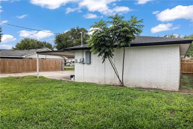 3614 Capri Dr, Corpus Christi, TX 78415 - view of property exterior featuring brick siding, a carport, a patio area, and a shingled roof