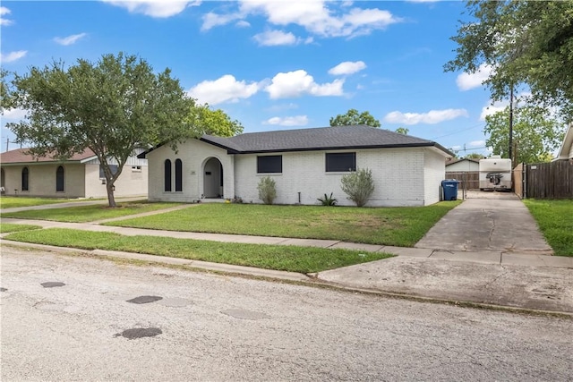 3614 Capri Dr, Corpus Christi, TX 78415 - single story home with concrete driveway, brick siding, and a gate