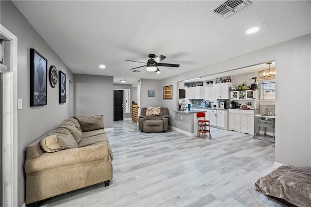 3614 Capri Dr, Corpus Christi, TX 78415 - living area featuring a ceiling fan, light wood-type flooring, recessed lighting, and a chandelier