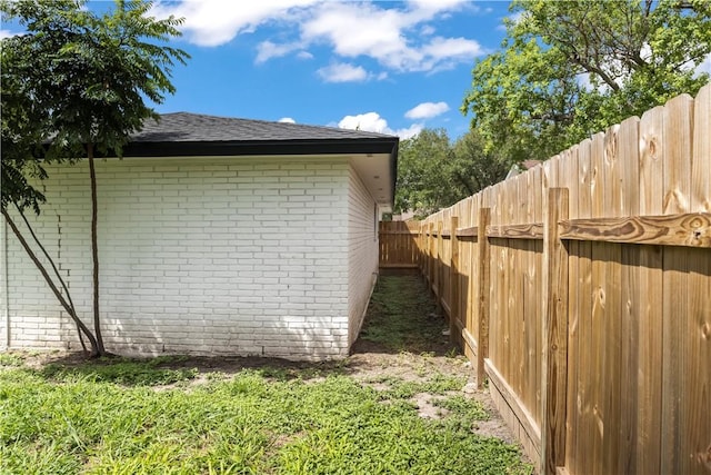 3614 Capri Dr, Corpus Christi, TX 78415 - view of side of home featuring brick siding, a shingled roof, and a fenced backyard