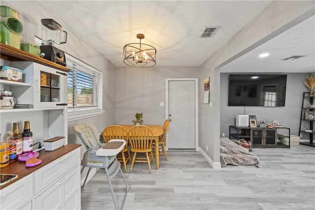 3614 Capri Dr, Corpus Christi, TX 78415 - dining room featuring light wood-type flooring, a chandelier, and recessed lighting