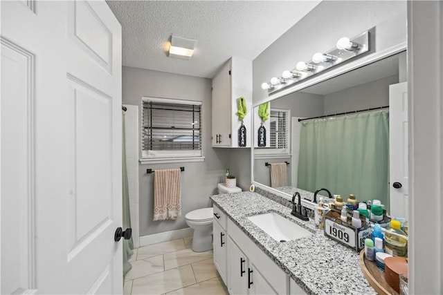 3614 Capri Dr, Corpus Christi, TX 78415 - bathroom with vanity, marble look tile flooring, a textured ceiling, and curtained shower