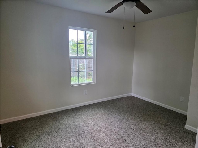 1540 Daytona Dr, Corpus Christi, TX 78415 - empty room with ceiling fan, dark carpet, and baseboards