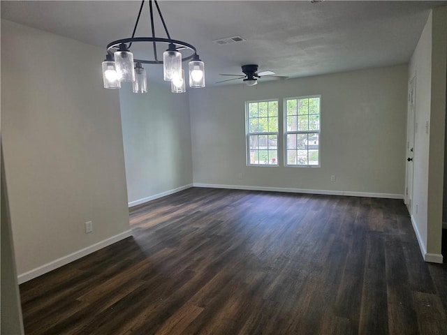 1540 Daytona Dr, Corpus Christi, TX 78415 - empty room featuring dark wood-style floors, a chandelier, ceiling fan, and baseboards
