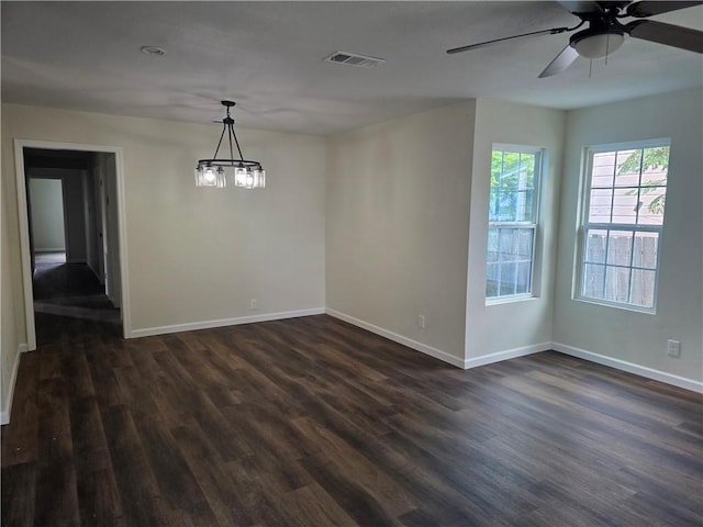 1540 Daytona Dr, Corpus Christi, TX 78415 - spare room featuring baseboards, dark wood-style floors, ceiling fan, and a chandelier