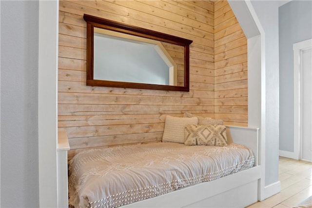 bedroom featuring wood walls