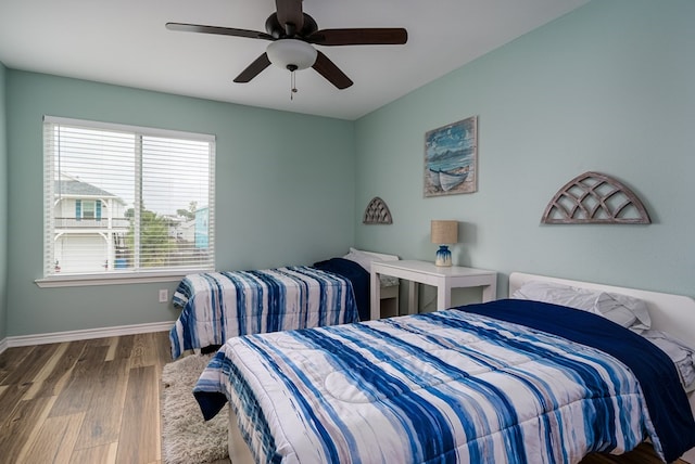 bedroom with hardwood / wood-style flooring and ceiling fan