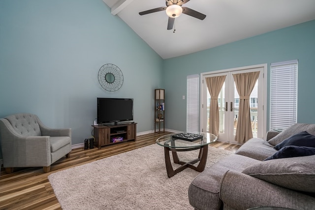 living room with hardwood / wood-style flooring, high vaulted ceiling, and ceiling fan