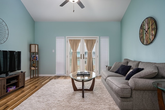 living room featuring hardwood / wood-style flooring, ceiling fan, lofted ceiling, and french doors