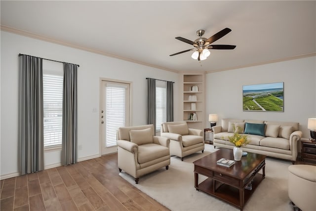 living room featuring hardwood / wood-style floors, ceiling fan, and crown molding