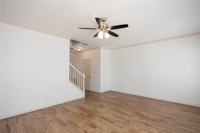 unfurnished room featuring hardwood / wood-style floors, ceiling fan, and crown molding