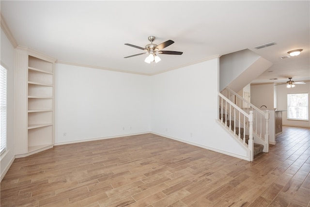 unfurnished room featuring ceiling fan, ornamental molding, and light hardwood / wood-style flooring