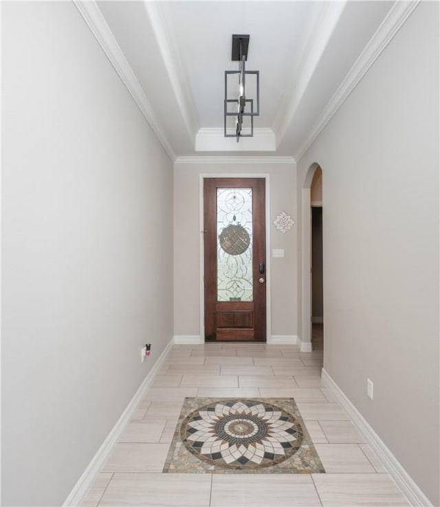 3141 Piranha Dr, Corpus Christi, TX 78414 - foyer entrance featuring arched walkways, ornamental molding, baseboards, a raised ceiling, and wood tiled floors