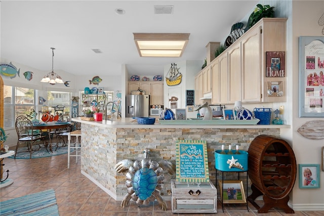 kitchen with an inviting chandelier, stainless steel fridge with ice dispenser, light tile patterned floors, and decorative light fixtures