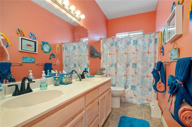 bathroom with curtained shower, vanity, and toilet