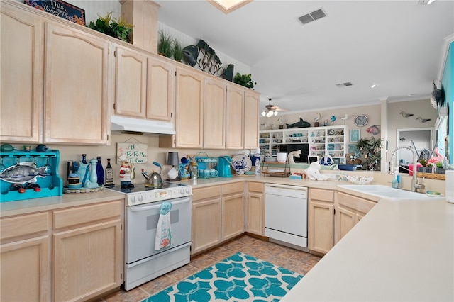 kitchen with light brown cabinetry, white appliances, and sink