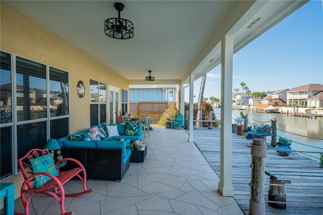 view of patio with outdoor lounge area and a water view