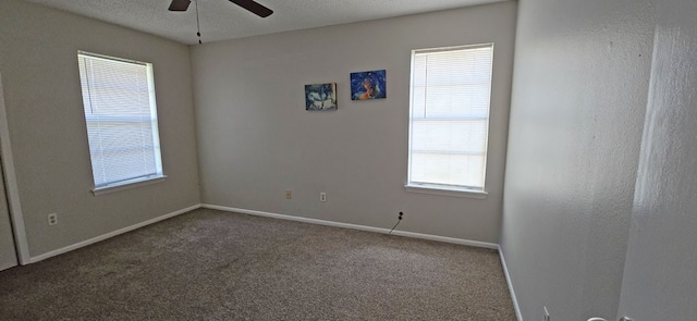 carpeted spare room with ceiling fan and a textured ceiling