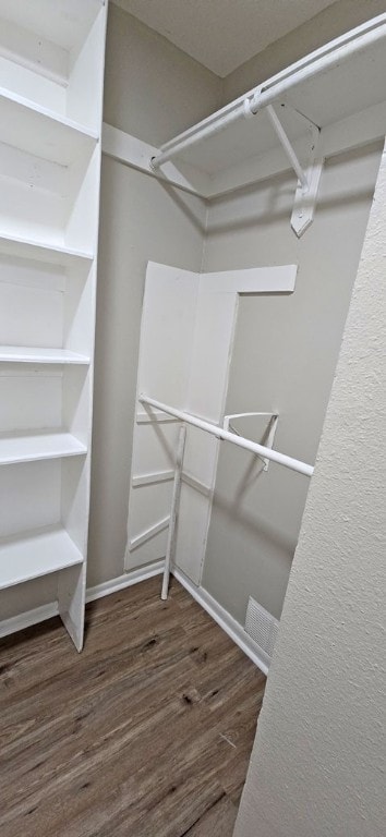 walk in closet featuring dark hardwood / wood-style floors