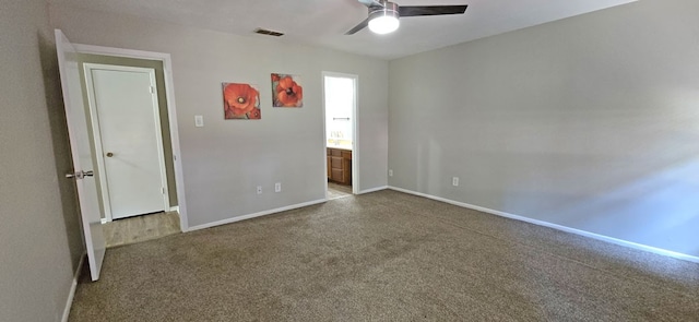 unfurnished bedroom with connected bathroom and ceiling fan