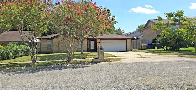 view of front of house with a garage and a front lawn