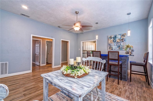 10634 Veda Dr, Corpus Christi, TX 78410 - dining space featuring wood finished floors, a ceiling fan, and a textured ceiling