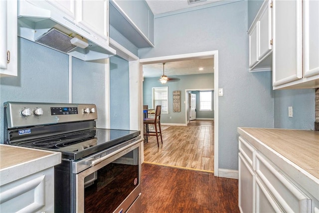 10634 Veda Dr, Corpus Christi, TX 78410 - kitchen featuring electric range, dark wood-type flooring, white cabinetry, under cabinet range hood, and a ceiling fan