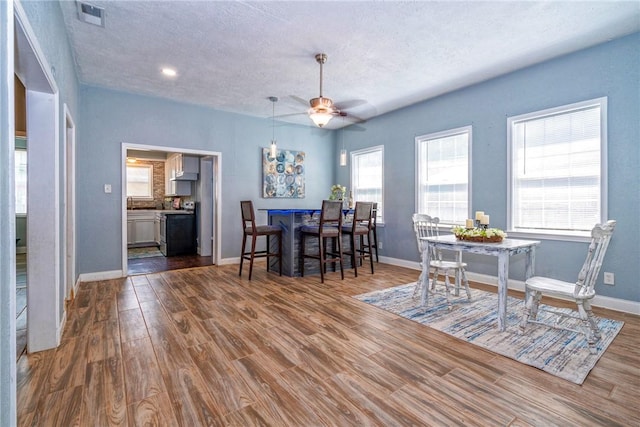 10634 Veda Dr, Corpus Christi, TX 78410 - dining room with a ceiling fan, wood finished floors, a textured ceiling, and recessed lighting