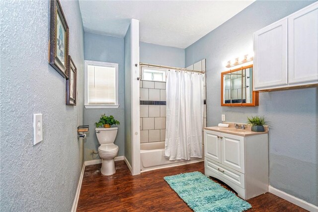 10634 Veda Dr, Corpus Christi, TX 78410 - full bathroom featuring vanity, wood finished floors, shower / bath combo with shower curtain, and a textured wall
