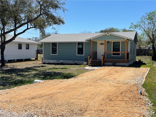 view of front of property featuring covered porch and fence