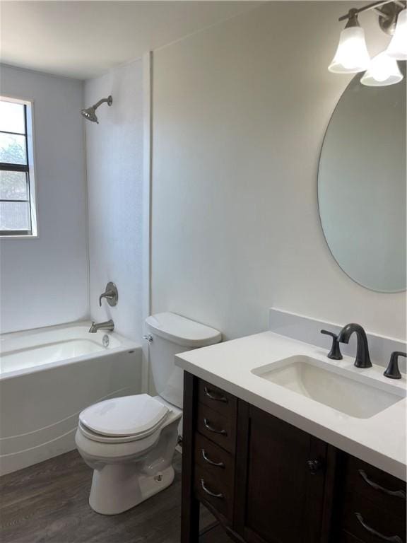 full bathroom featuring vanity, bathing tub / shower combination, toilet, and wood finished floors