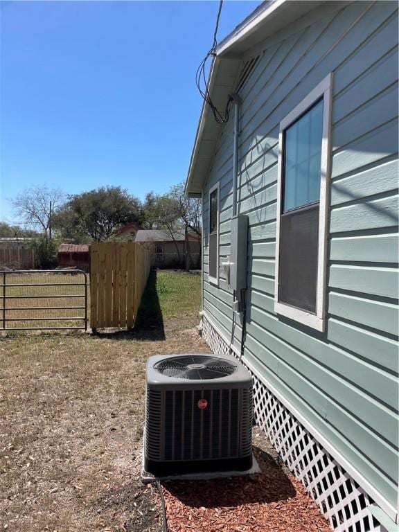 view of home's exterior featuring central AC unit and fence