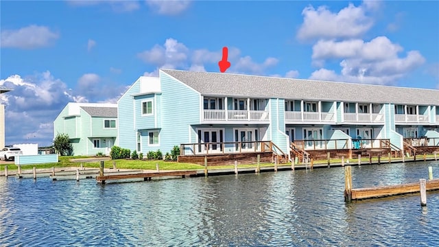 exterior space featuring a water view and a balcony