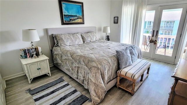 bedroom with hardwood / wood-style flooring, access to exterior, and french doors