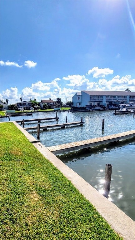 dock area featuring a yard and a water view