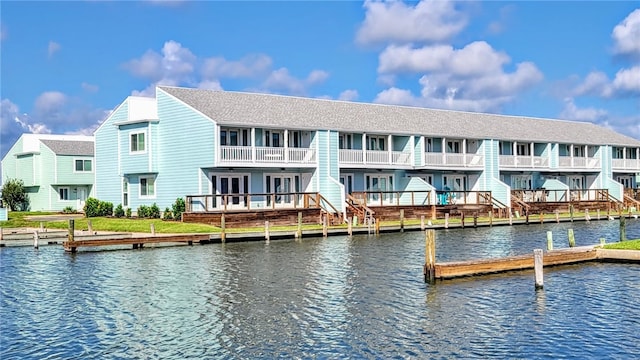 exterior space featuring a balcony and a water view