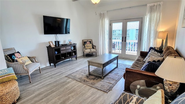 living room featuring light wood-type flooring and french doors